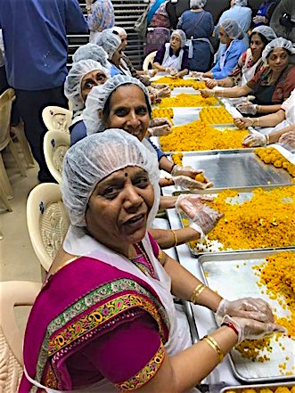 Volunteers say that making and serving food builds community. By Naimi Patel